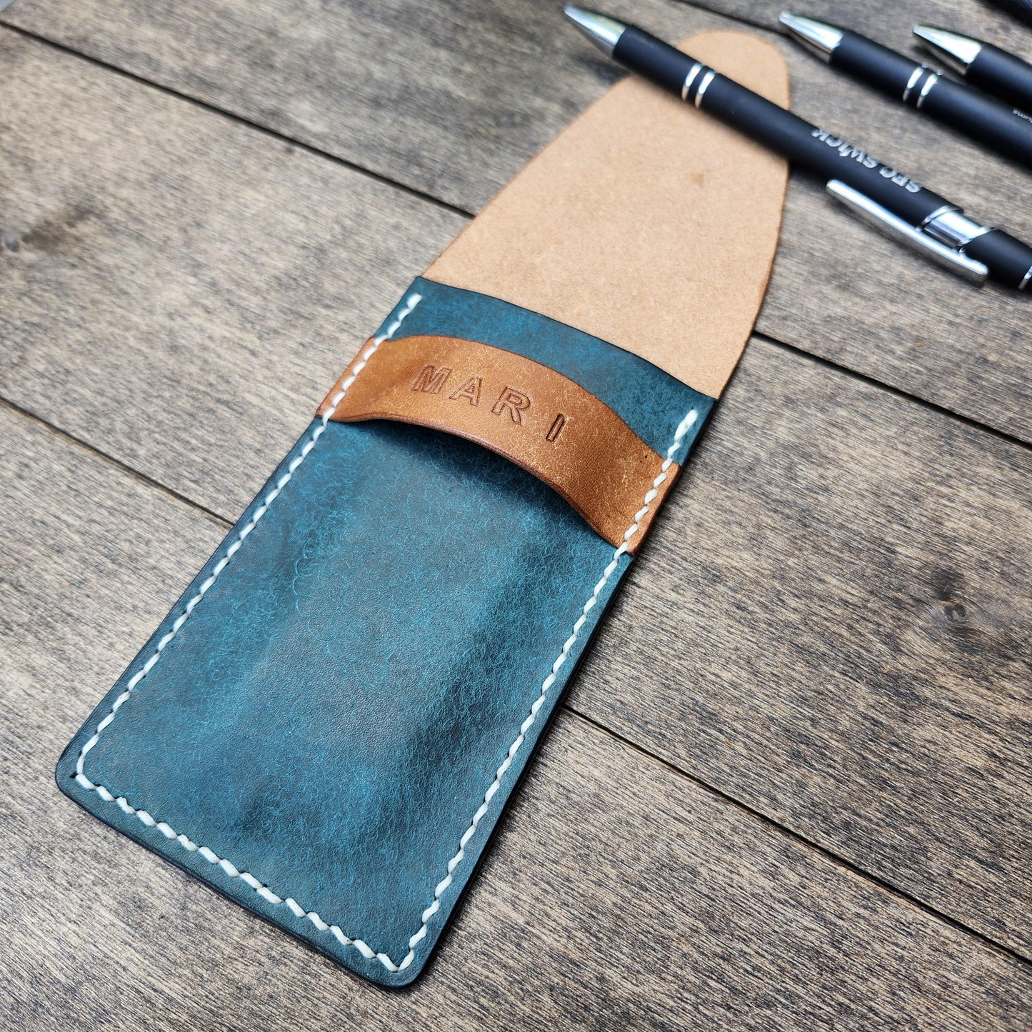 Handmade Leather Case open empty with pens laying in background