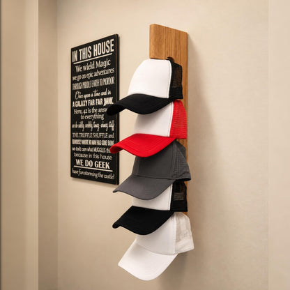 Handmade oak wall-mounted hat rack displaying a collection of baseball caps